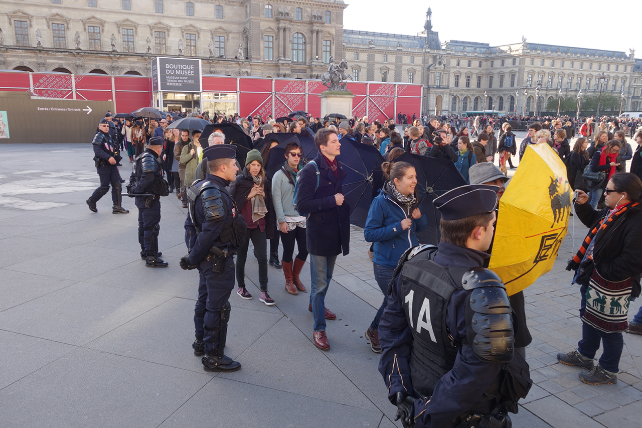 Guards and protesters in front of the Louvre