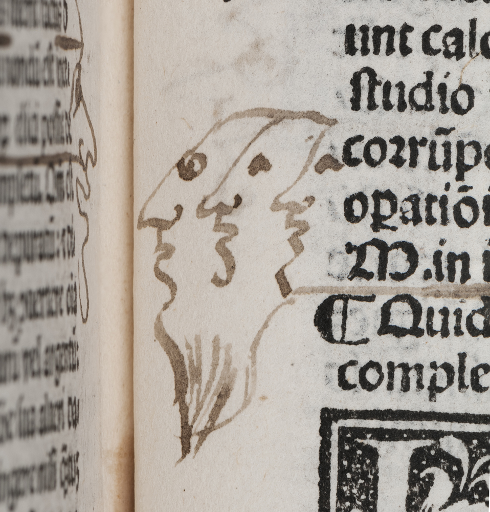 John Dee's doodle of three bearded faces in the margin of a treatise on alchemy (Arnaldus de Villanova, 'Opera,' published Venice, 1527) (© Royal College of Physicians / Mike Fear)