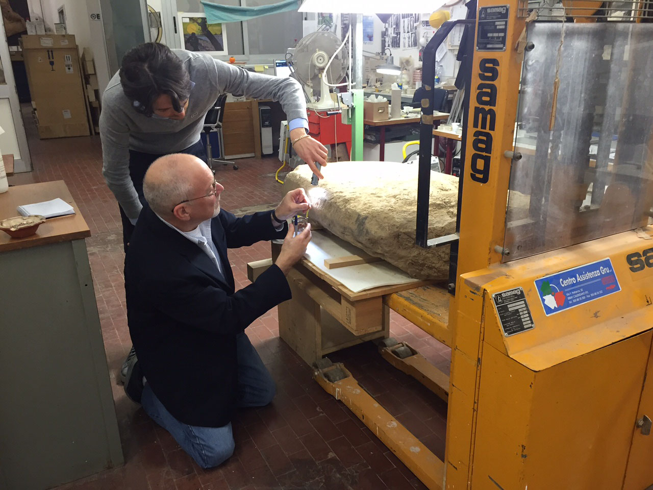 Scientists examining the Etruscan stele (courtesy Mugello Valley Project)