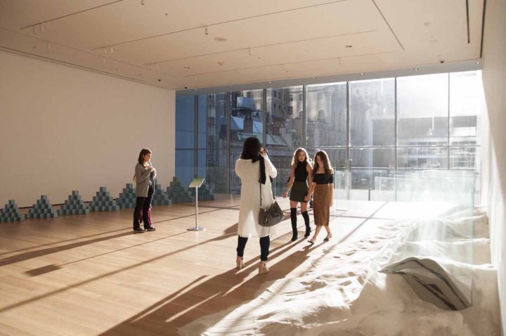 Visitors make their way downstairs to the meditation as sunlight streams through the windows of the Museum of Modern Art.