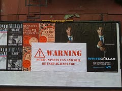 A photo of a NYSAT billboard at 13th Street & Avenue B by Veken Gueyikian