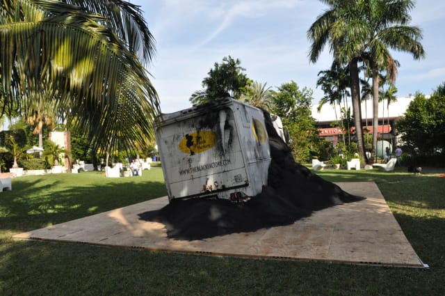 William Pope L., "The Black Factory" (2002-2009) in the Botanical Garden with a view of the Art Basel Miami venue in the background. (click to enlarge)