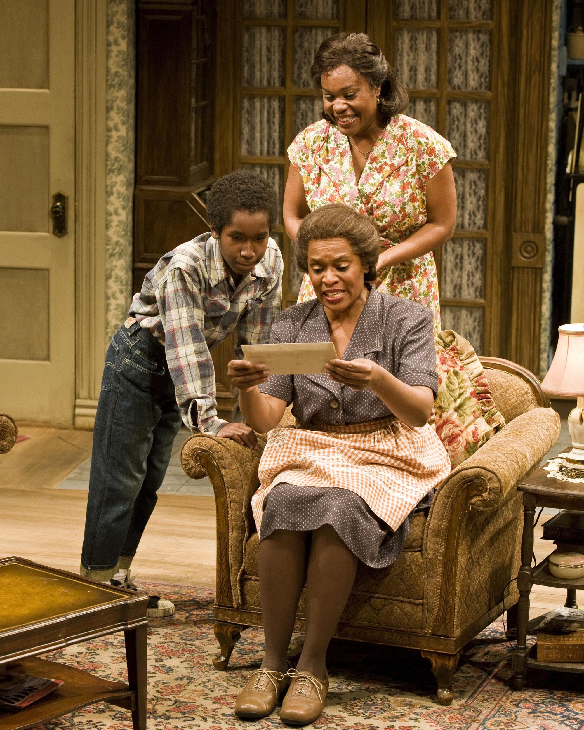 No, they're not reading tweets, but the audience was.  Clockwise from the left: Brandon David Brown, Deidrie Henry and Kim Staunton in the Ebony Repertory Theatre production of “A Raisin in the Sun” by Lorraine Hansberry at Center Theatre Group’s Kirk Douglas Theatre.