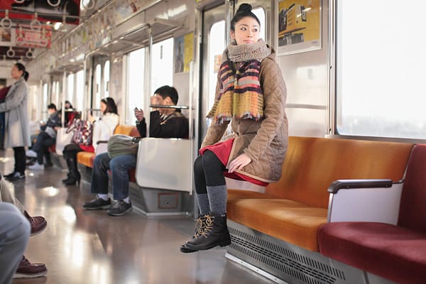 For her May 30 levitation, "Yowayowa Camera Woman" Natsumi Hayashi demonstrates a perfectly reasonable solution to avoiding subway seat grime. 