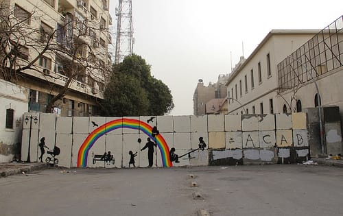 One mural depicts silhouettes of children and families.  Image on a CC license by Mosa'ab Elshamy.