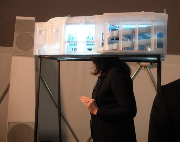 Woman with head in architectural model