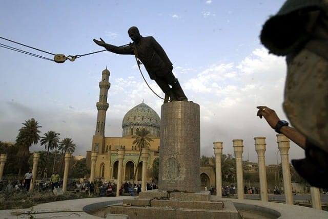 Hussein statue being removed by troops in Iraq. Photograph by Jerome Delay.