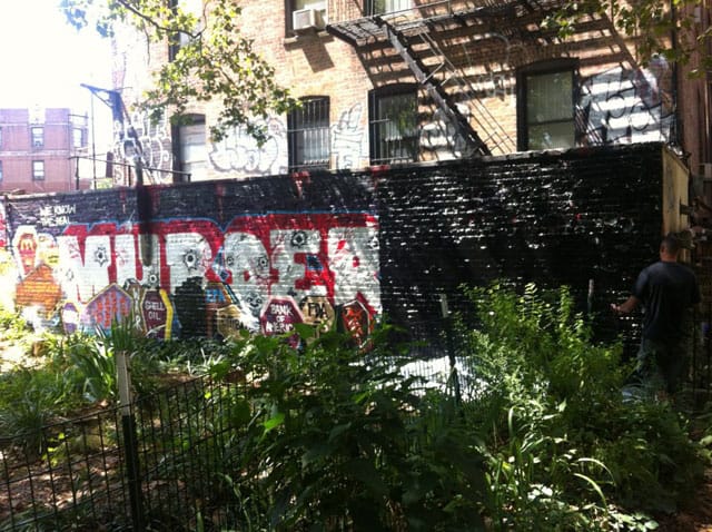 Plainclothes officers painting over the "Murderers" mural