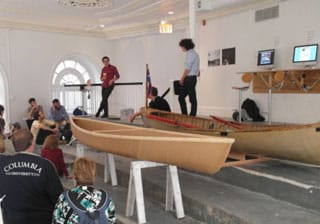 Members of art collective Mare Liberum showing off their handmade paper skiffs