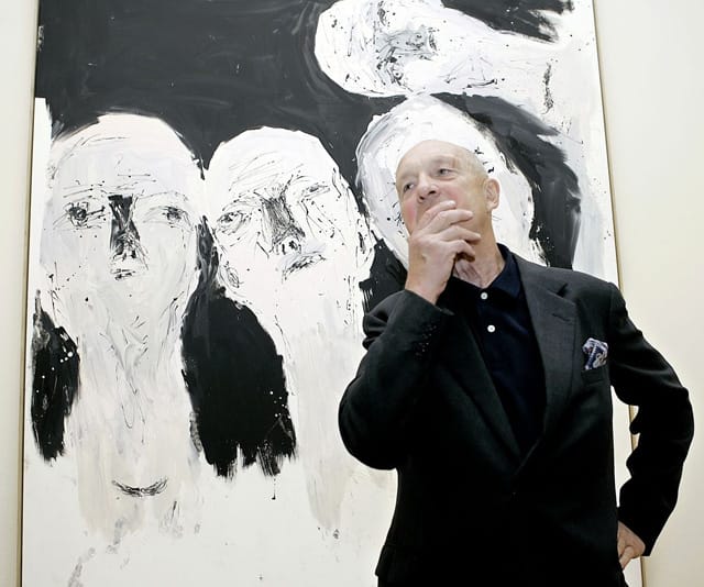Georg Baselitz in front of one of his paintings (image via fansiter.com)