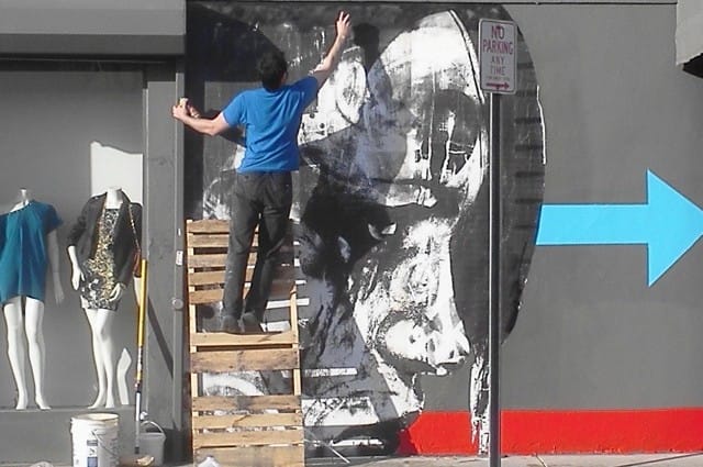 Leeman using a pallet from a dumpster to paint, "????" for Miami Basel, 2012, image courtesy the artists.