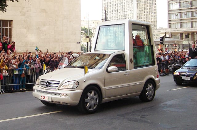 Pope Benedict XVI in the Popemobile (via)