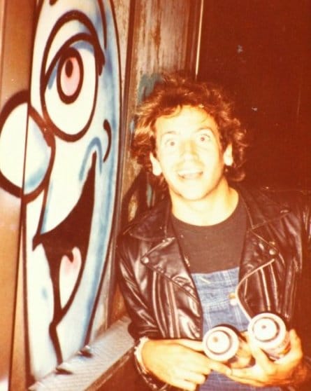 Kenny Scharf in 1982 with the work on the street that got him arrested. (courtesy the artist)