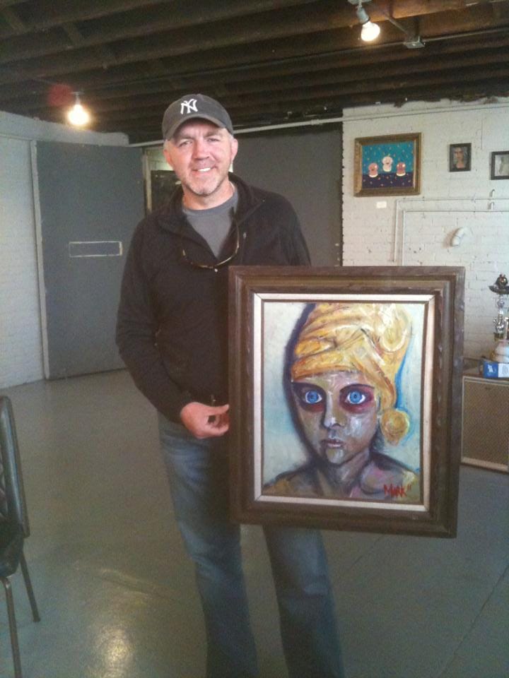 A Gallery 530 owner with his painting (Image via Gallery 530's Facebook)