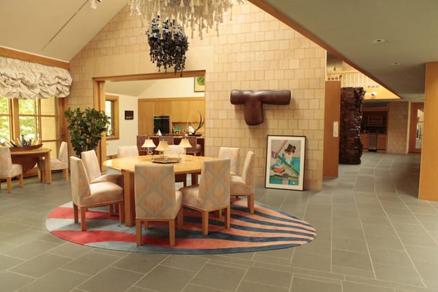 Petah Coyne's "Untitled 811," and "Untitled 858" (both unknown year) hang above the dining room, while Peter Shelton's "Onelongsleeve" (1989) hangs on the wall.