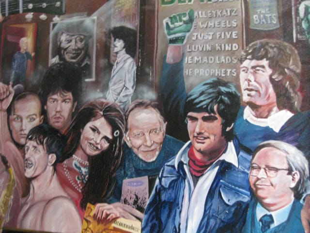 Mural in courtyard of Duke of York Brighton with soccer star Geoge Best in foreground