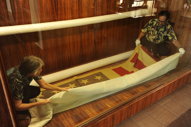 Conservation at the U.S. Pacific Air Forces of a flag that flew over a 1941 battle (photograph via U.S. Pacific Air Forces)