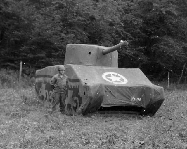 A Ghost Army soldier stands next to a rubber M4 Sherman tank, 93 pounds fully inflated. (image courtesy the National Archives and PBS)