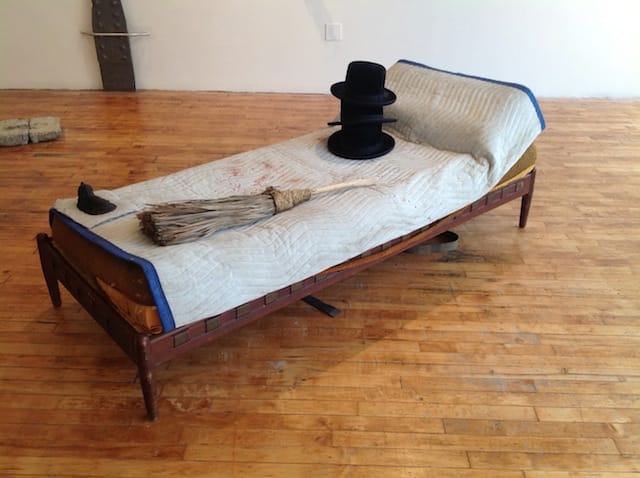 Matt Freedman, "Hats and Broom on Bed with Drinking glass Reflecting Full Moon" (2013). Epoxy  plastic, found objects, 36 x 72 x 18 inches.