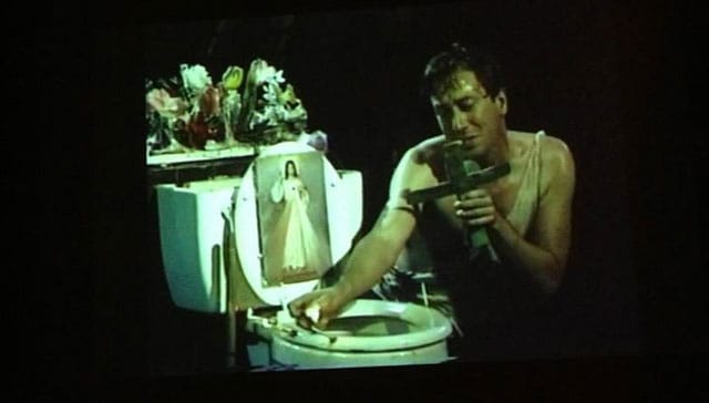 Photo of film screening John Fleck performing in his work Blessed are all the Little Fishes, 1989.  (Source: New Museum)