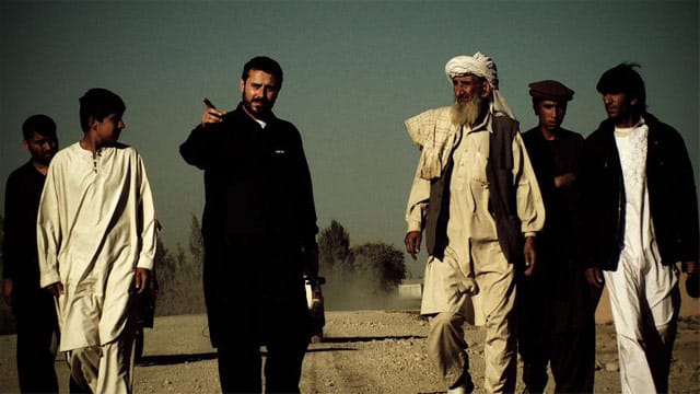 Jeremy Scahill walking with villagers in Gardez, Aghanistan in a film still from "Dirty Wars," directed by Richard Rowley