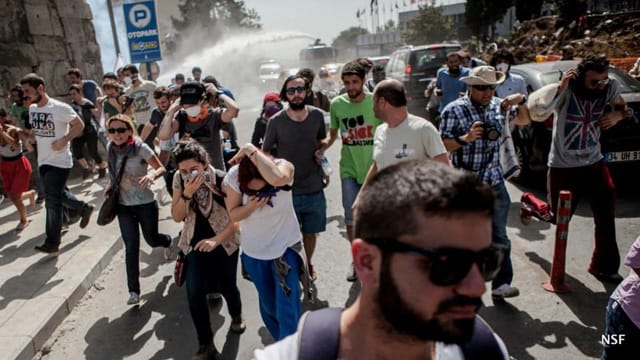 Protesters escape from one of the police’s panzers as it fires water and pepper spray liberally. (Photo: Nazim Serhat Firat, and used with permission)