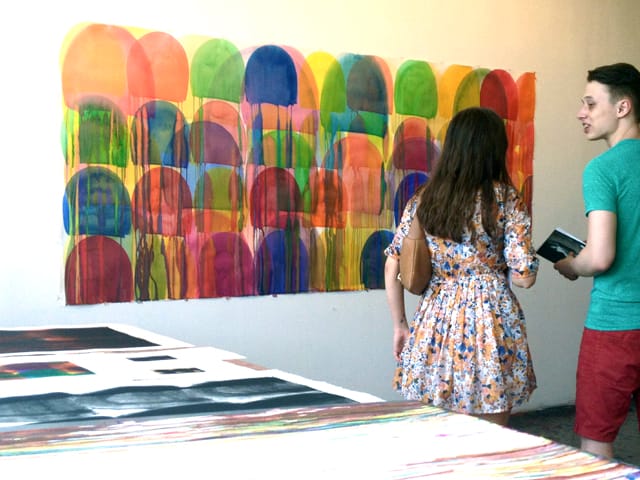 Viewers discuss an untitled watercolor from 2013 by Svetlana Rabey at Bushwick Open Studios.