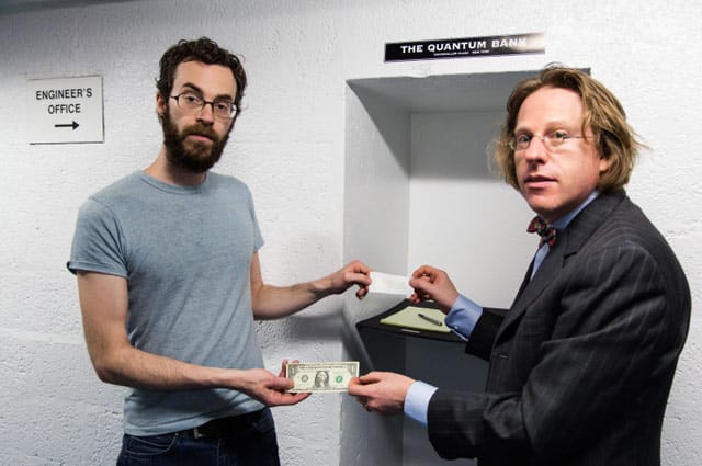 Artist Jonathon Keats (right) completes a transaction with a customer at the Quantum Bank. (all Quantum Bank photos via engineersofficegallery.com)