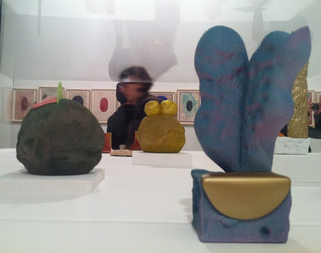 Various ceramic sculptures by Rob Nagle (1980s–present) in the foreground, with anonymous Tantric paintings in the background