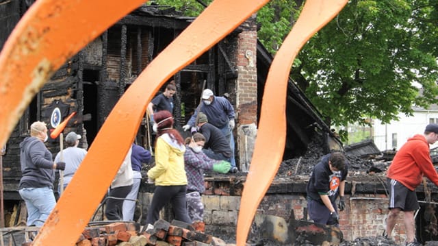 Volunteers cleaning up after the OJ House fire