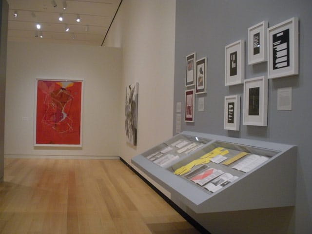 "Dannielle Tegeder: Painting in the Extended Field," installation view, with "“Hoshanouxmeh: Thermal Red Secret Universe Plan with Chemical Silver Suspended City with Classification of Color and Shape Language” (2013) in back left and documentation of conceptual projects in foreground right