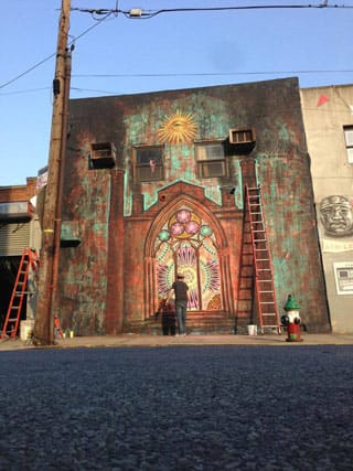 Beau Stanton working on his Bushwick Collective mural