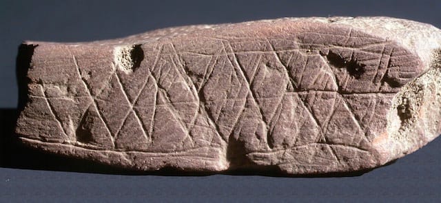 Engraved ochre from Blombos Cave. (image via the National Science Foundationa and courtesy of Chris Henshilwood)