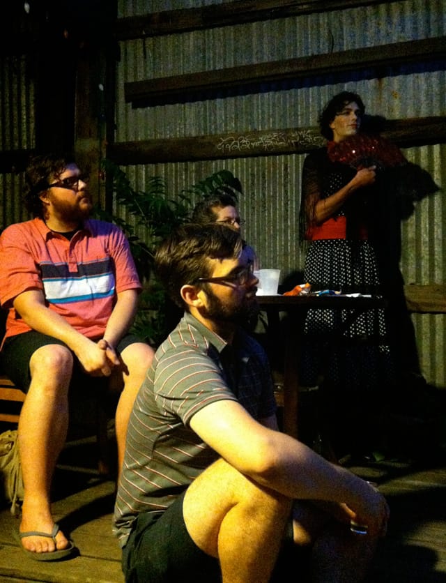 Audience members watch the Upholstery performance, and a jilted lover gets ready to enter the scene.