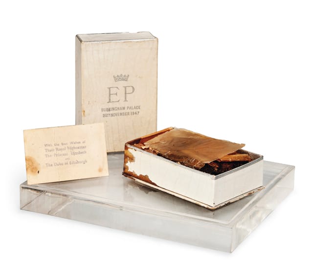 A SLICE OF FRUIT CAKE FROM QUEEN ELIZABETH II'S WEDDING, 1947 The slice of cake comes in a white cardboard presentation box with silvered lettering: a crown above `EP'/ Buckingham Palace/ 20th November 1947', in a later perspex case Case -- 3.1/2 in. (9 cm.) high; 7.1/2 in. (19 cm.) wide Estimate: £800-1,200