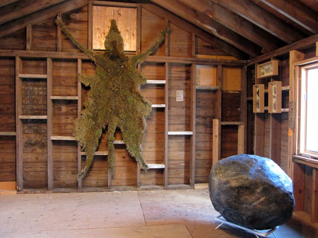 Markel Uriu, "The Pelt" (2013), moss, burlap, thread (left) and MaryKate Maher, "Scholars Rock" (2012), resin and steel (right)