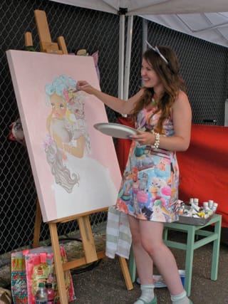 An artist paints a cat-unicorn (click to enlarge)