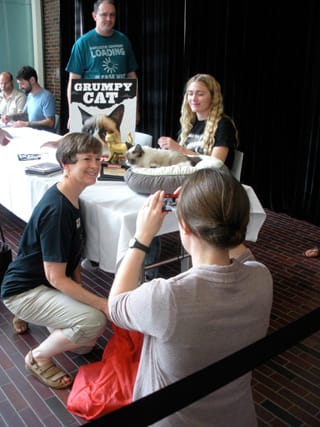 People getting their books signed and taking photos with Grumpy Cat (click to enlarge)