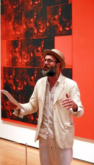 Kenneth Goldsmith reading at MoMA, in front of Andy Warhol's "Orange Car Crash Fourteen Times" (1963) (click to enlarge)