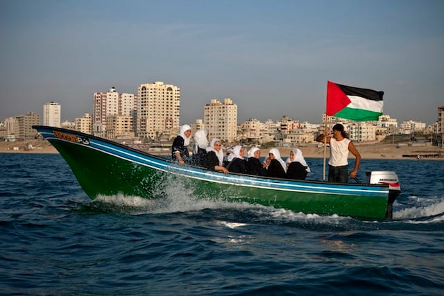 Tanya Habjouqa, from the series "Women of Gaza." Text for the photograph: "High school students enjoy a field trip on the Mediterranean Sea off the Gazan coast---the ten minute boat ride an adventure as they are not allowed to travel outside of the Gazan enclave due to the siege."