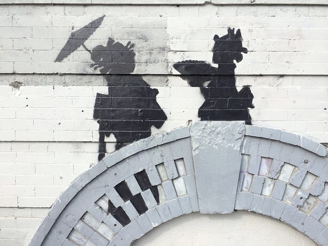 A detail of the Graham Avenue Banksy