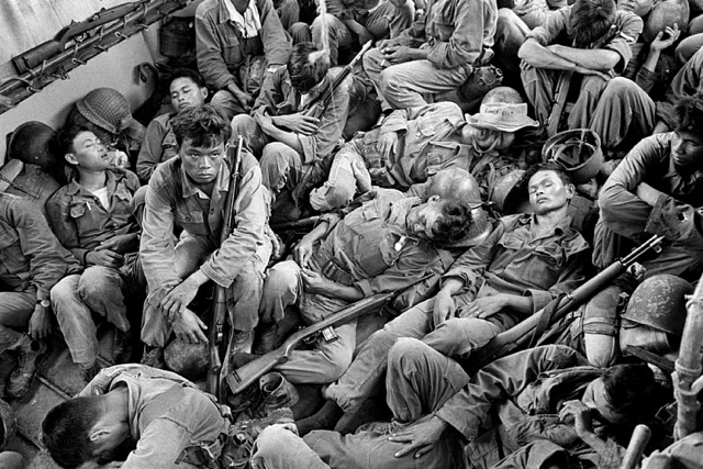 Horst Faas, "Exhausted South Vietnamese Soldiers Sleep on a U.S. Navy Troop Carrier Taking them Back to the Provincial Capital of Ca Mau" (August 1962), gelatin silver, printed 2013, 16 x 20 in (via stevenkasher.com)