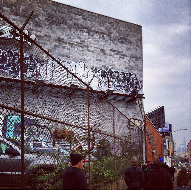 The men use a ladder to get up there.