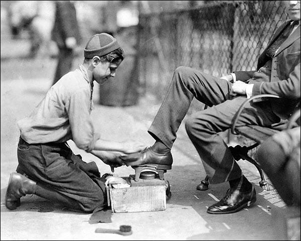 Tony, a twelve year old bootblack at his station in Bowling Green, New York City. photograph by Lewis Wickes Hines, 1924.