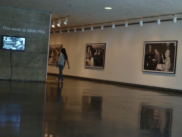 A visitor walks past Yang's black and white photographs depicting urban Shanghainese youth.