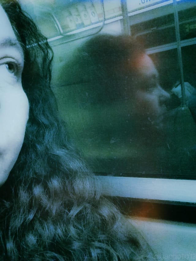 Olya Turcihin's subway selfie: "When I am on the subway, the act of taking pictures of myself and well as other passengers makes the time go by in a surrealist fashion."