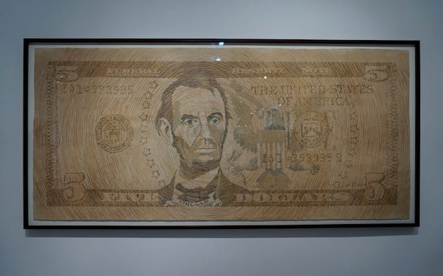 Ambreen Butt, "Untitled ($5 Bill)" (2013), shredded money, collage on tea stained paper, 45" x 89" (all photos by the author for Hyperallergic)