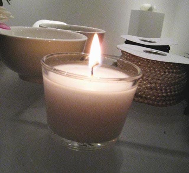 A lit candle opened Angela Freiberger’s performance, “Homage to Mandela.” (all photos by the author for Hyperallergic)