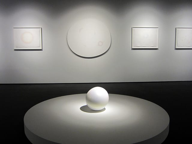 Mariko Mori, "Tama I" (2011), epoxy with pearlescent finish in front of drawings by Mori