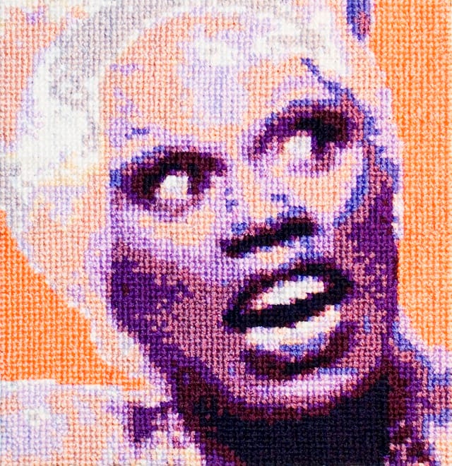 Aubrey Longley-Cook with 34 community participants, "RuPaul Cross Stitch Animation Workshop - Front View," (2013). Animated cross stitch, frame 17. Courtesy of the Artist. Photo Credit: Aubrey Longley-Cook